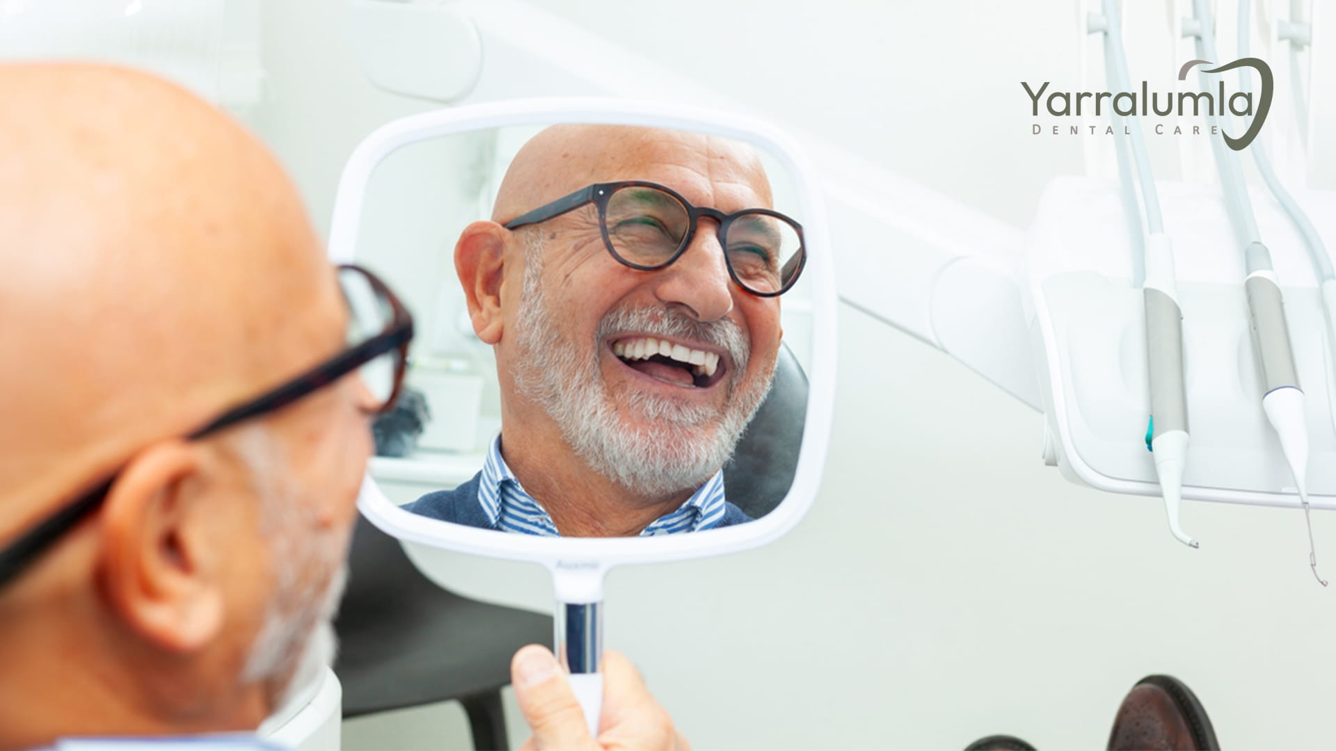 Happy patient holding mirror and checking teeth at dental clinic
