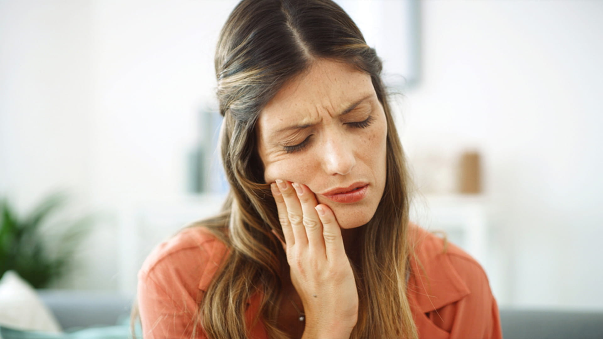 This image shows a person experiencing extreme dental discomfort who should consider consulting a qualified dental professional for prompt medical attention, as it looks like a dental emergency.